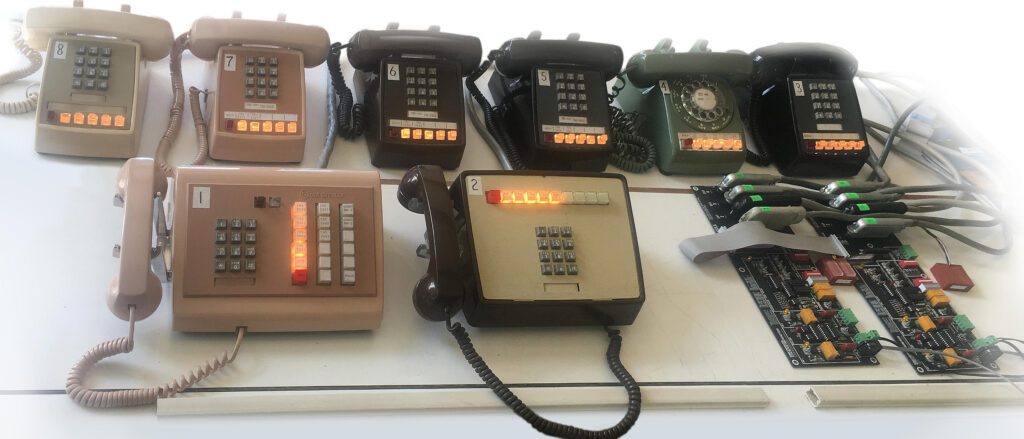 Photograph of a fully maxed-out Seriss 1A2 key system, shown with vintage telephones.